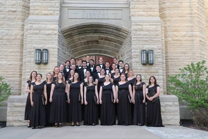 A choral stands at the stairs of a Chapel 